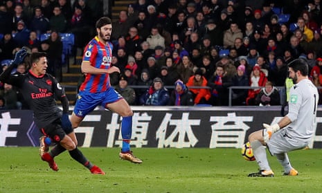 Arsenal’s Alexis Sánchez slots his second goal past the  Crystal Palace goalkeeper Julian Speroni with defender James Tomkins powerless to intervene.