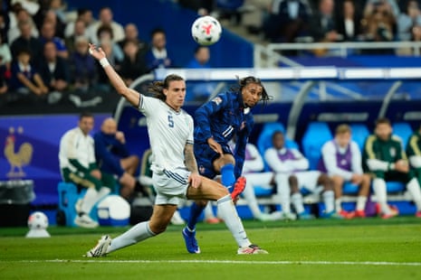 Italy's Riccardo Calafiori, (left) is unable to stop a shot by France's Michael Olise, which ends up going wide of the Italian goal.