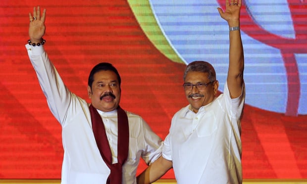 Mahinda Rajapaksa (left) and his brother Gotabaya Rajapaksa waving to supporters during a party convention held to announce Gotabaya’s presidential candidacy in 2019.