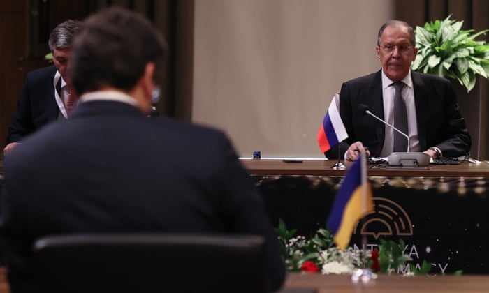 Russia’s foreign minister, Sergei Lavrov, sits in front of his Ukrainian counterpart, Dmytro Kuleba, during a tripartite meeting chaired by the Turkish foreign minister, Mevlüt Çavuşoğlu, in Antalya, Turkey.