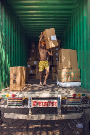 Man carries boxes off truck