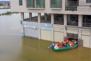 Qingyuan, China Volunteers use a boat to evacuate villagers stranded by the floodwater