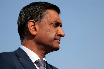 a man in a suit looks to the side