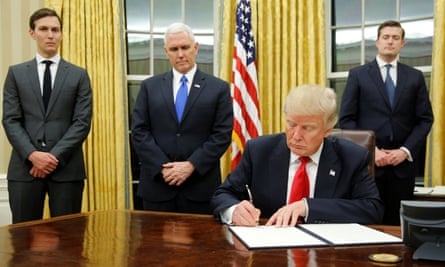 Jared Kushner stands beside vice-president Mike Pence as Donald Trump signs his first executive orders on inauguration day.