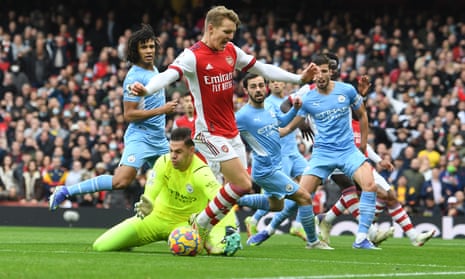 Arsenal’s Martin Ødegaard tangles with Ederson, the Manchester City goalkeeper.