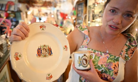 Brecken Armstrong displays commemorative items she is purchasing to remember Queen Elizabeth II during a visit to the Rose Tree Cottage English Tea Room in Pasadena, California 
