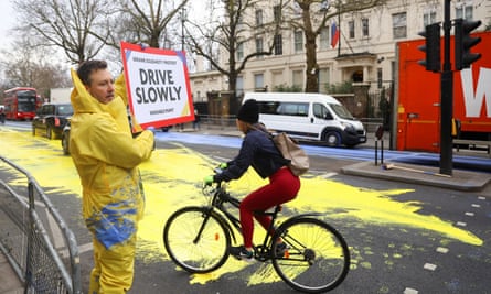 Led By Donkeys paint a Ukrainian flag outside the Russian embassy in 2023