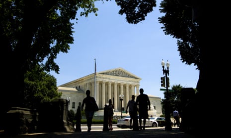 People walk outside of the supreme court in Washington on Tuesday.