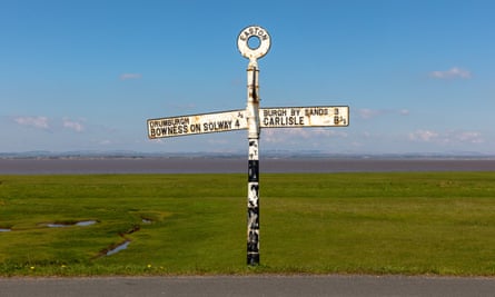 Black and white signpost at Easton, pointing west to Bowness-on-Solway and east to Carlisle