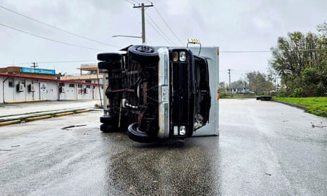 An overturned truck in Guam, after Typhoon Mawar passed over the island.