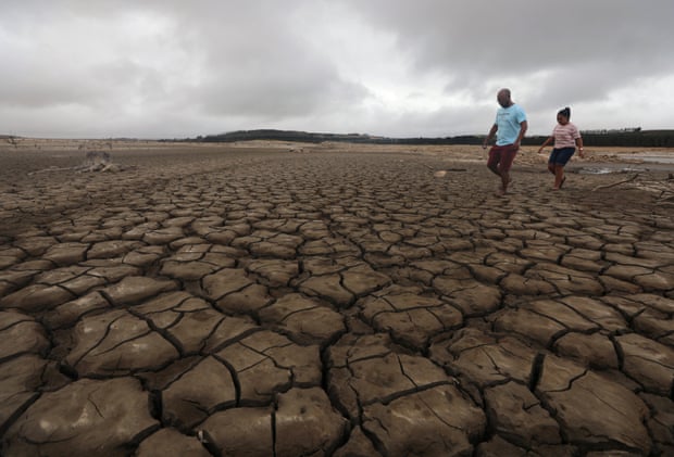 A family negotiates their way around a dried-up section of the Theewaterskloof dam near Cape Town.
