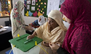 A woman casts her vote at a polling station in Islamabad, in the Pakistan election 2018.
