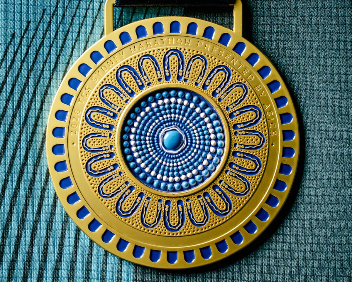 The reverse of the medal featuring an indigo and gold Indigenous design