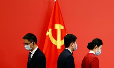 Officials prepare the podium before members of the new Politburo Standing Committee meet with the media after the 20th National Congress of the Communist Party of China held at the Great Hall of the People in Beijing.
