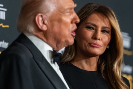 Melania Trump watches as President Donald Trump speaks on the red carpet before the awards ceremony
