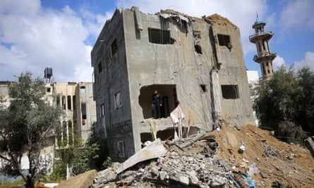 People carry out search and rescue operations in the rubble of destroyed buildings after an Israeli attack at the Nuseirat refugee camp in Gaza on 10 April.