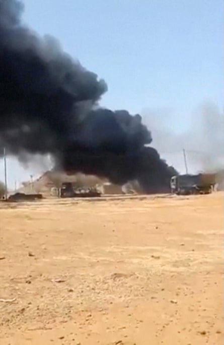 Black smoke rises from the site of an attack on a military base