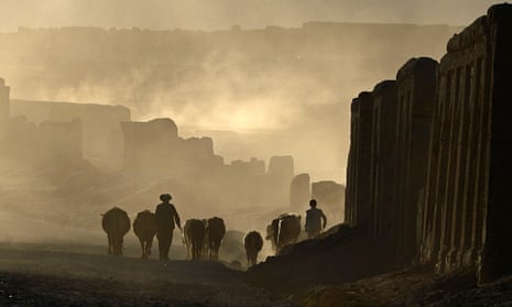 An Afghan Hazara shepherd walks with his flock on the former Silk Road that once linked China with Central Asia and beyond. 