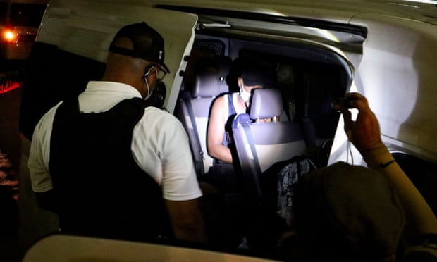 Members of the National Migration Institute (INM) talk to a migrant detained during a raid by the migration authorities and members of the Mexican National Guard, in Tapachula, Mexico, in February.