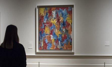 An exhibition-goer stands before False Start by Jasper Johns in an exhibition at the Royal Academy in London last year.