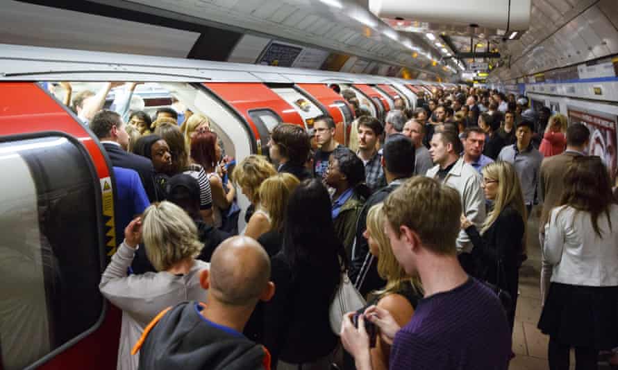 Commuters queuing for tube trains at Green Park Tube Station
