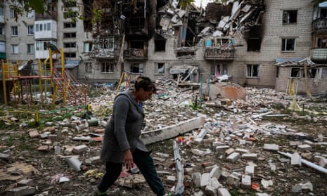 Person among badly damaged flats