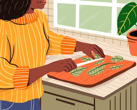 Woman chopping vegetables on cutting board in kitchen at home