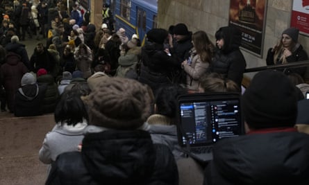 People rest in a Kyiv metro station being used as a bomb shelter during a rocket attack on Monday.
