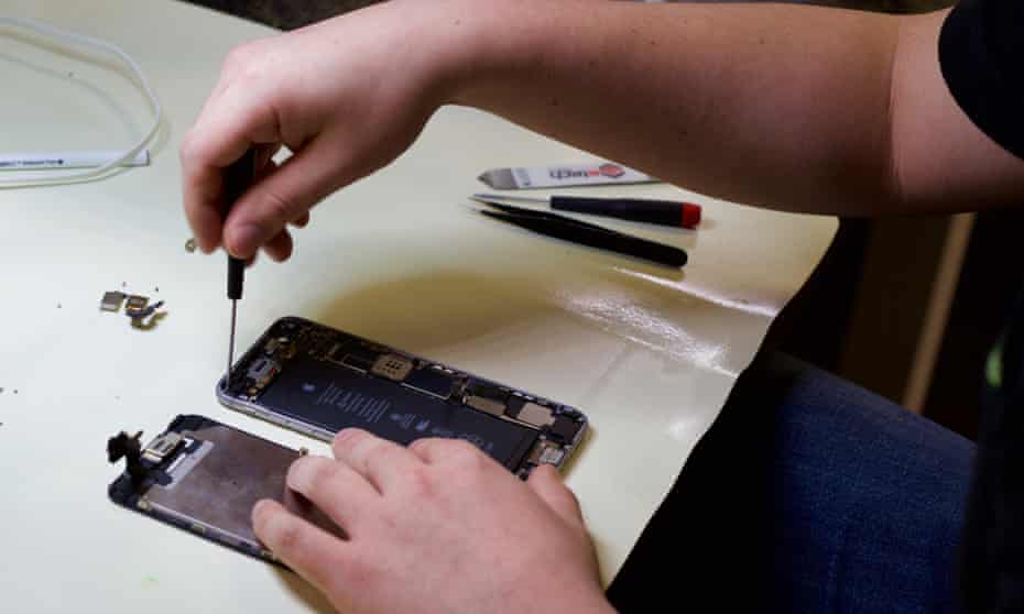 File photo of a technician treating a water-damaged iPhone