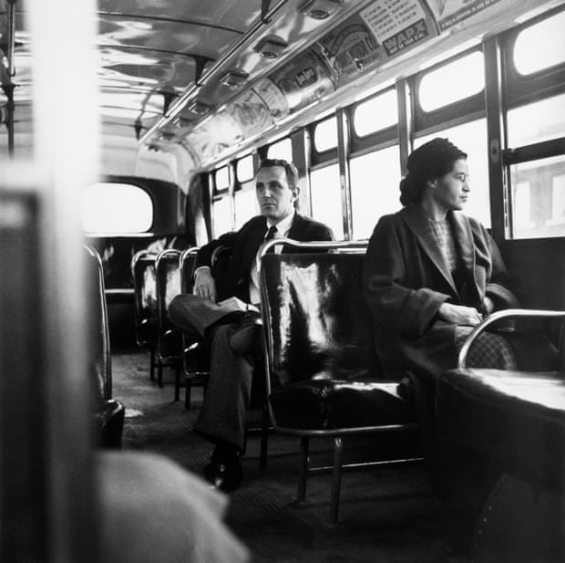 American civil rights activist, Rosa Parks sits in the front of a bus in Montgomery, Alabama, after the Supreme Court ruled segregation illegal on the city bus system on December 21st, 1956; the man sitting behind Parks is Nicholas C. Chriss, a reporter for United Press International out of Atlanta