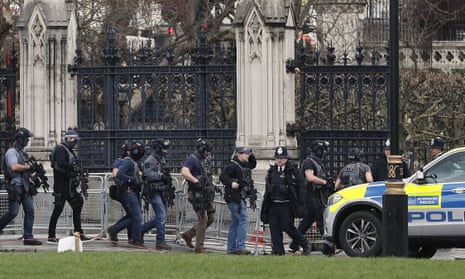 Armed police officers enter the Houses of Parliament