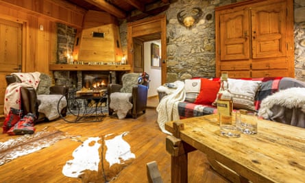 Sitting room with open fire in an AliKats chalet.