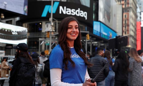 A Coinbase employee takes a selfie outside the Nasdaq building in New York on flotation day. 