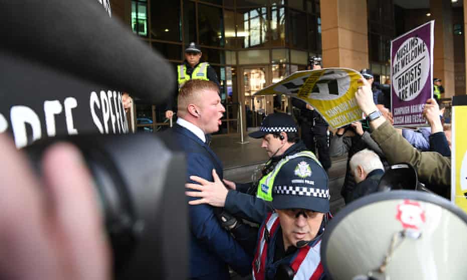 United Patriots Front leader Blair Cottrell (left) confronts antifascist protesters outside the Melbourne magistrates court where he faced racial vilification charges brought after protests in Bendigo