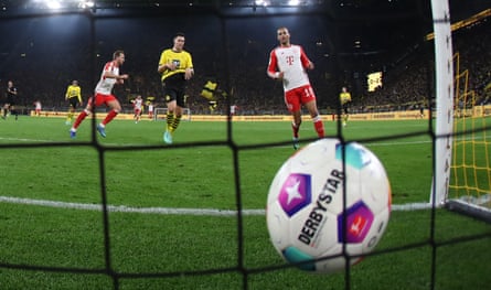 Harry Kane (left) scores one of his three goals against Dortmund.
