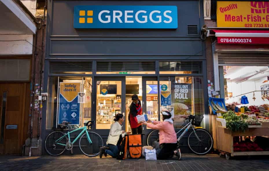 Girija Tase, 27 and Alex Brickman, 28, collect leftover food from Greggs in Brixton to deliver to a homeless outreach centre at Chandler Community Hall