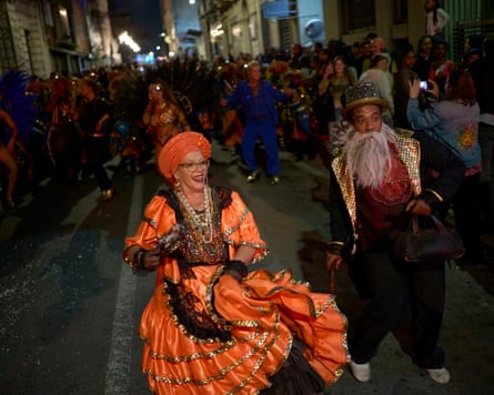 Performers from the Lonjas de Ciudad Vieja comparsa dance to candombe music during the Corso de la Ciudad Vieja in Montevideo.