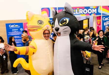 people smile while dressed in cat costumes