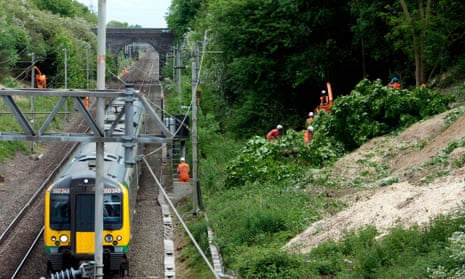 Engineers cut down trees beside the West Coast Main Line, Northamptonshire.