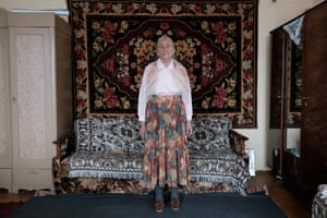 Photographs of Vera wearing clothes that tell her story by photographer Tatsiana Tkachova.