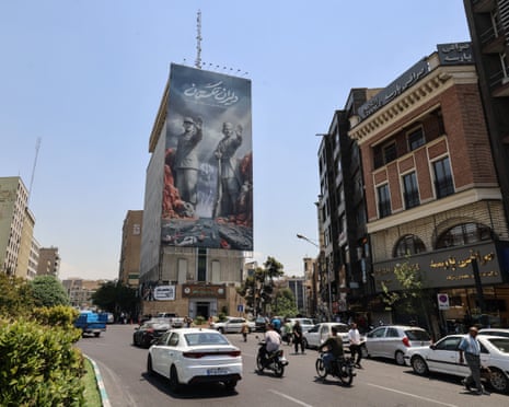 Commuters drive past a large banner depicting the closure of the strait of Hormuz in Tehran