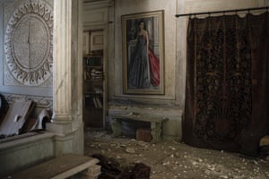 Debris from the ceiling and walls covers the floor in the palace. After the country’s 1975 to 1990 civil war, the palace was restored in a 20-year project