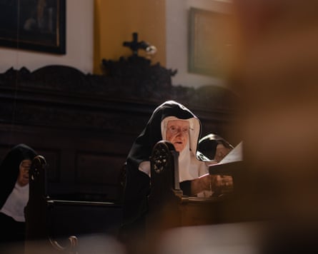 One of the nuns sits in a pew in the chapel