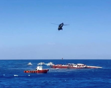 A helicopter winches a passenger