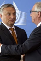 European Commission President Jean-Claude Juncker, right, shakes hands with Hungarian Prime Minister Viktor Orban.