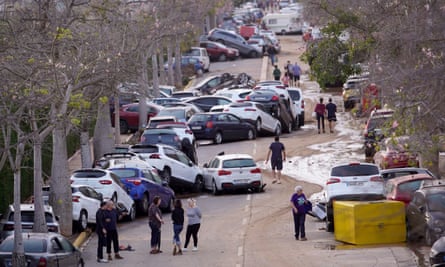Cars piled up after being swept away by floods in Paiporta