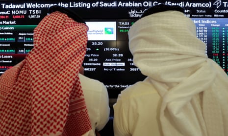 Investors monitor the Saudi stock exchange during Saudi Aramco’s IPO on the Riyadh stock market, in December.
