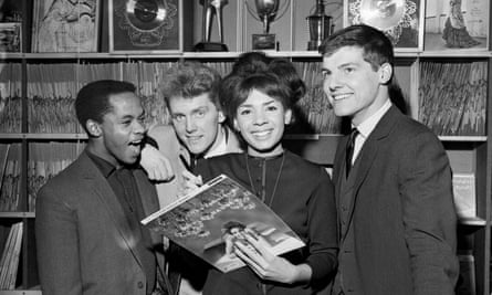 The four look at a record in a record shop