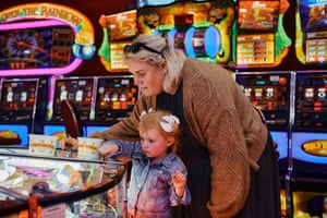 A mother and daughter play arcade games on Paignton pier