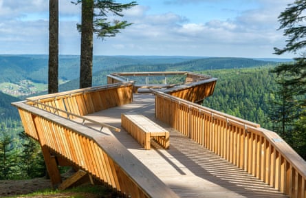 Long wooden platform offering a view of forests and hills